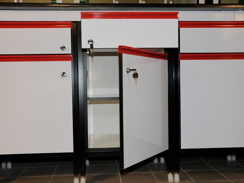 Lockable chemical storage cabinets with an open door showing internal shelving