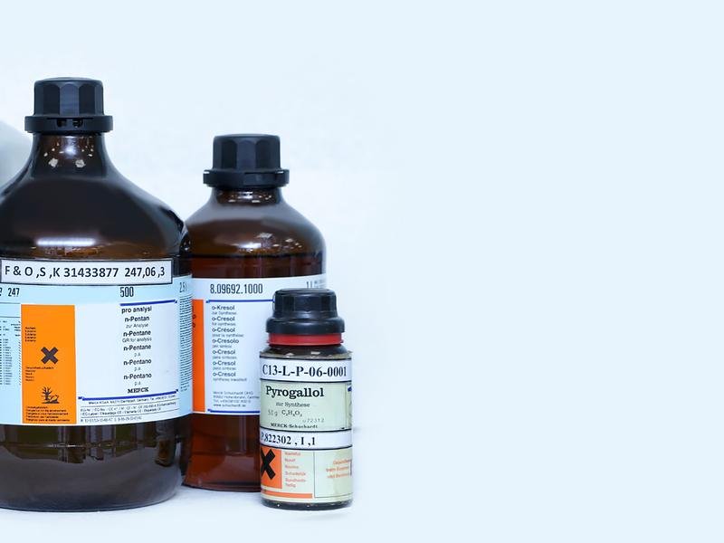 Laboratory reagent and solvent bottles with hazard labelling